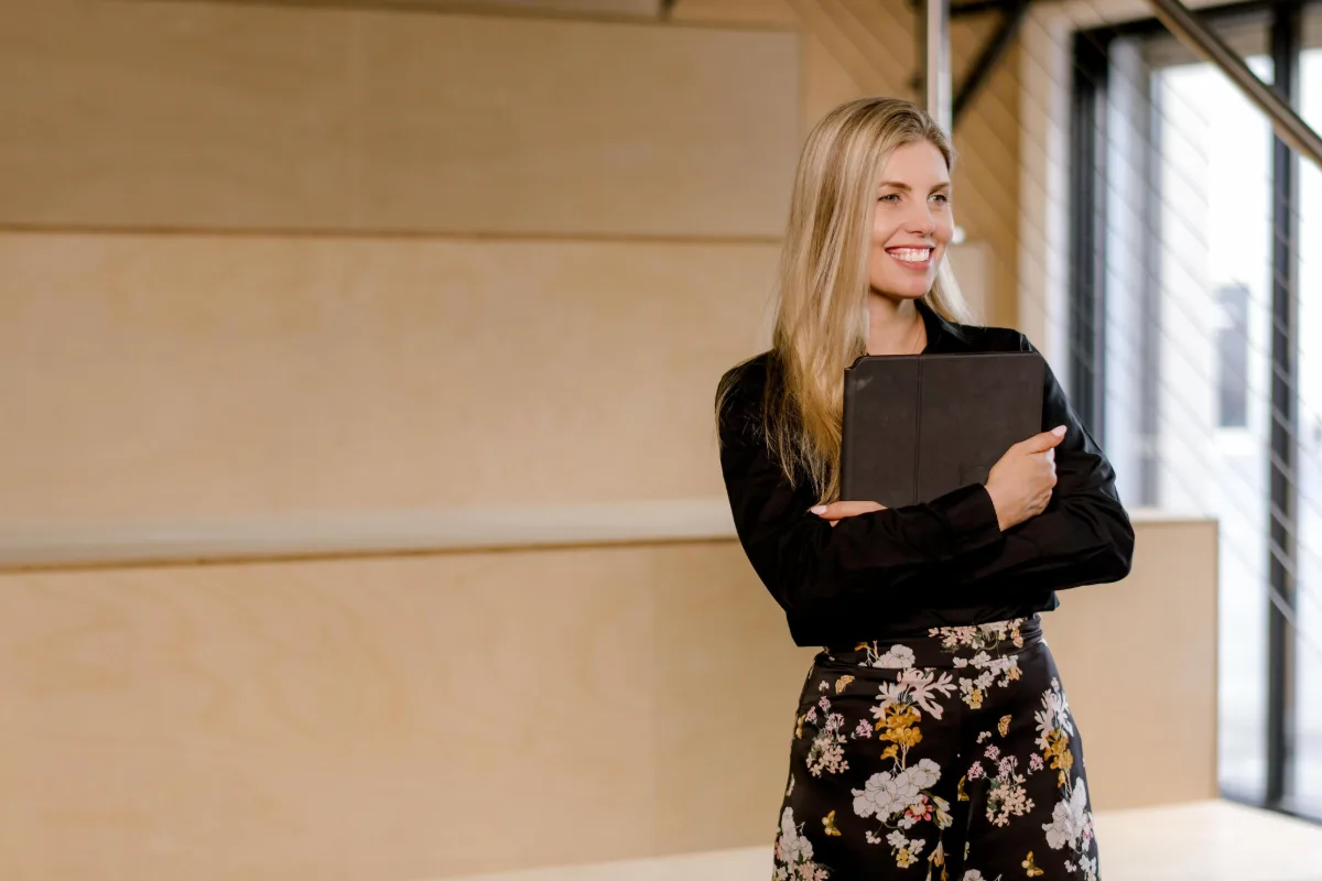 Smiling lawyer holding a tablet in a bright office