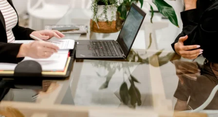Notebook, laptop and plants on a meeting table